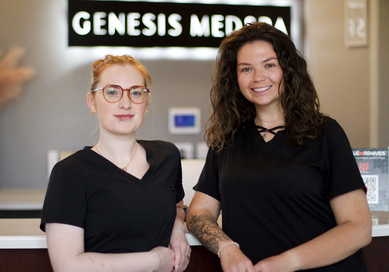 Two Genesis MedSpa team members at the Colorado Springs reception desk.